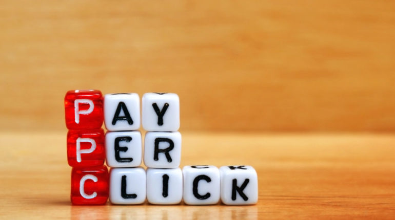 PPC Pay Per Click text on  dices on wooden background